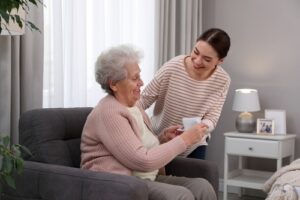 Caregiver helping an older adult at a professional adult day care center, representing how to find quality adult day care services near you.