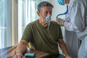 Senior with COPD receiving home care support while using oxygen therapy in a comfortable home setting