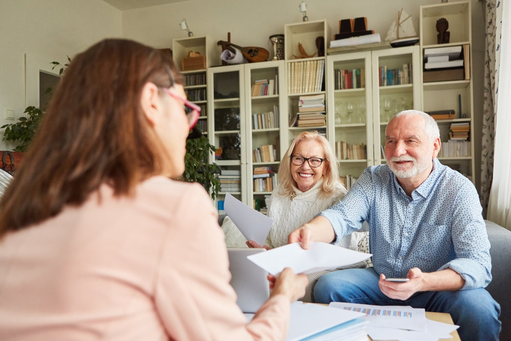 Home health aide helping a senior with mobility while providing in-home medical support