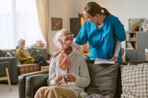 Caregiver assisting an elderly person at home with daily activities and companionship. at-home elderly care