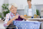 Care coordinator assisting a person with multiple sclerosis at home through NHTD services