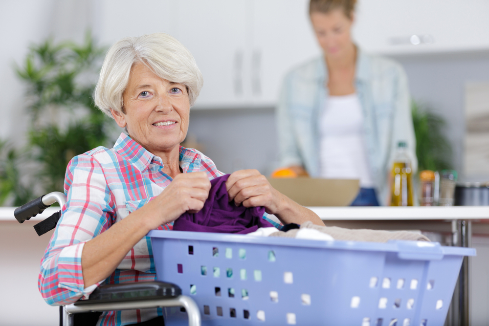 Care coordinator assisting a person with multiple sclerosis at home through NHTD services