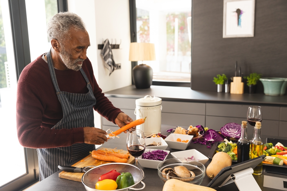 Senior adult receiving assistance from a caregiver while performing daily living activities at home, highlighting support with mobility and personal care.